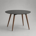 Table à manger ronde en MDF effet marbre noir avec pieds en bois massif brun, Ø 100 × H 75 cm
